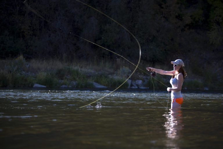 A woman fly fishing on the Provo River