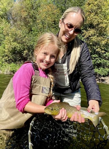A happy mother and daughter with a nice Provo River brown trout near Salt Lake City.