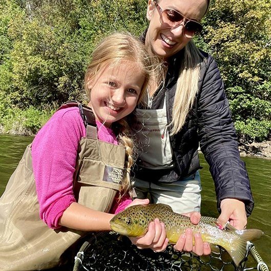 A happy mother and daughter with a nice Provo River brown trout near Salt Lake City.
