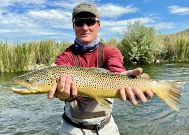 A Jeremy Allan Fly Fishing client holding a large brown trout