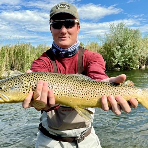 A Jeremy Allan Fly Fishing client holding a large brown trout