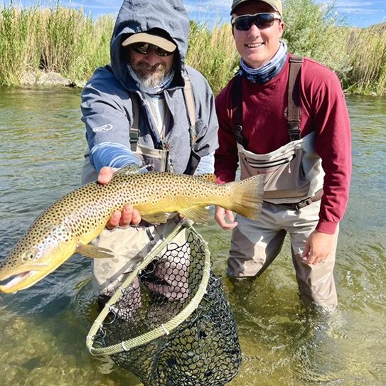 Guide Jeremy Allan with a happy client from one of our small stream guided fly fishing trips.