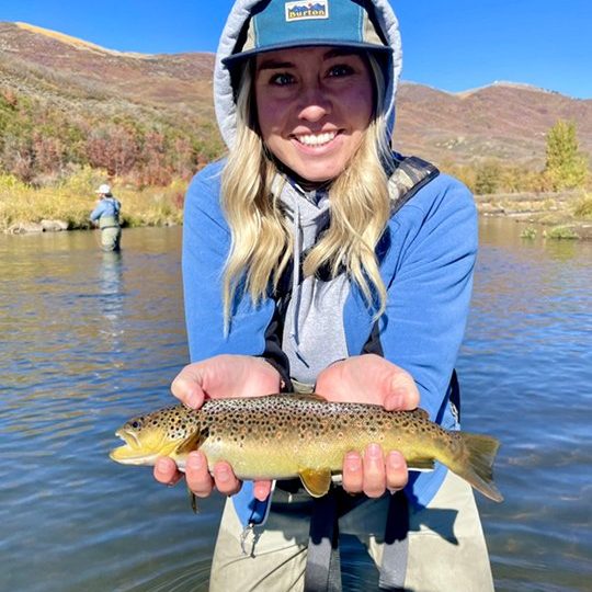 A happy girl with a nice brown trout on a beauty of a Fall day.