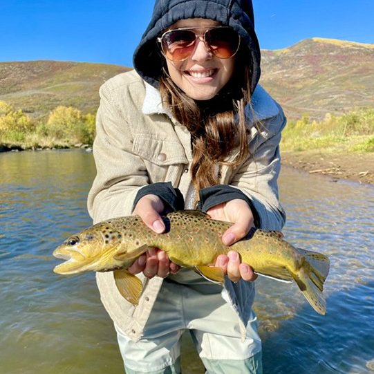 A happy lady with a nice Provo River brown trout on a beautiful Fall day.