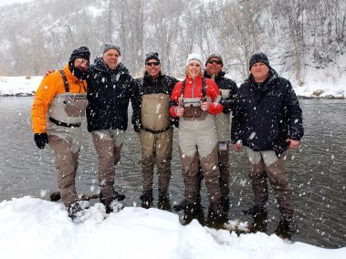 Group of happy fly fisherman in the snow