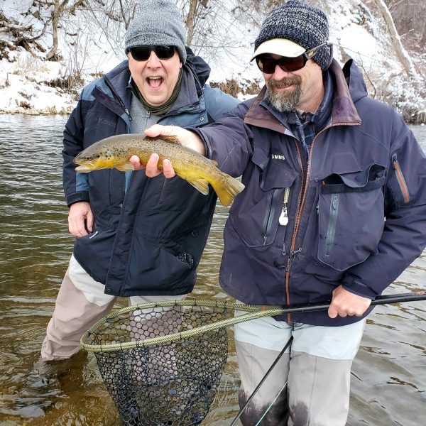 Winter fly fishing in Utah, Jeremy Allan holding a brwon trout caught on the Provo River