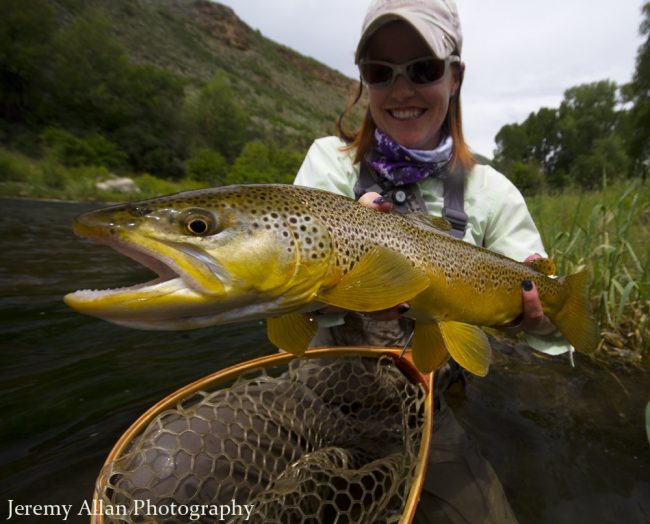 Green Drakes Utah Lady holding a big brown trout caught during a Green Drake hatch.