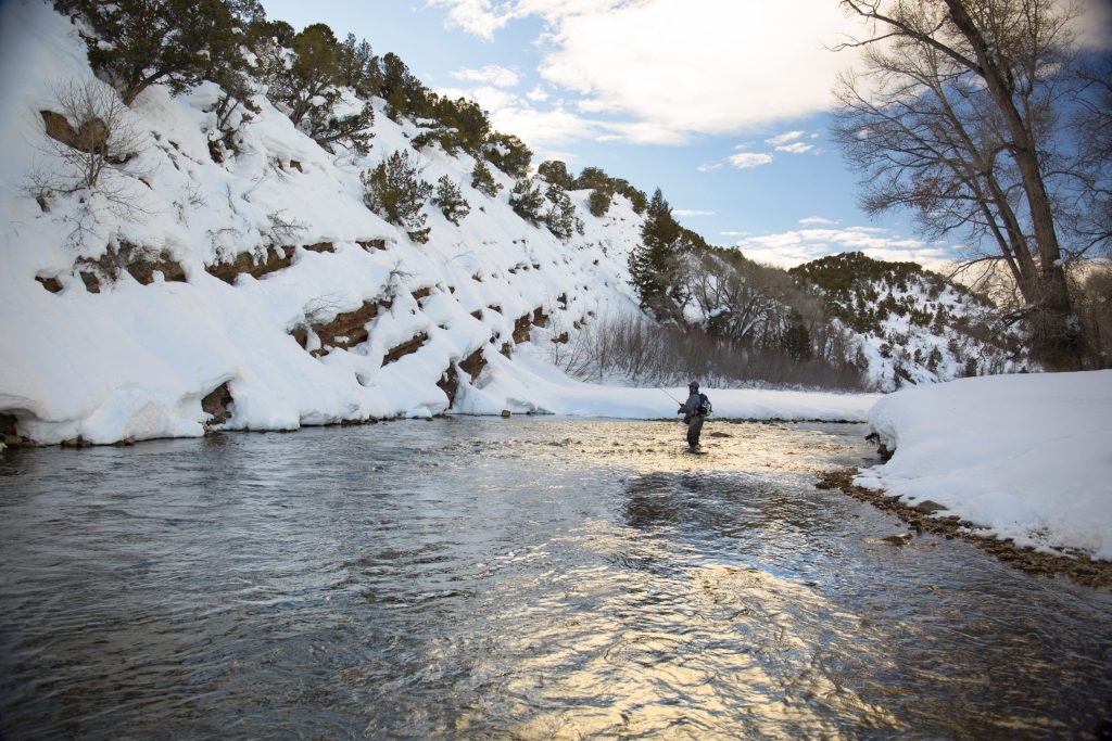 Winter Fly Fishing In Utah Winter fly fishing in Utah. A fly fisherman fishing during the Winter