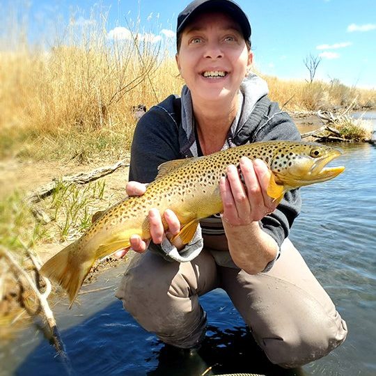 A Jeremy Allan Fly Fishing customer with a big brown trout