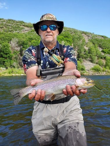 A Jeremy Allan Fly Fishing customer with a big brown trout on the Provo River