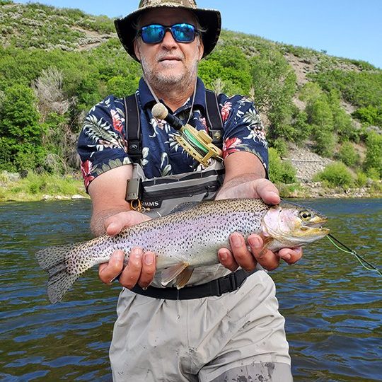 A Jeremy Allan Fly Fishing customer with a big brown trout on the Provo River