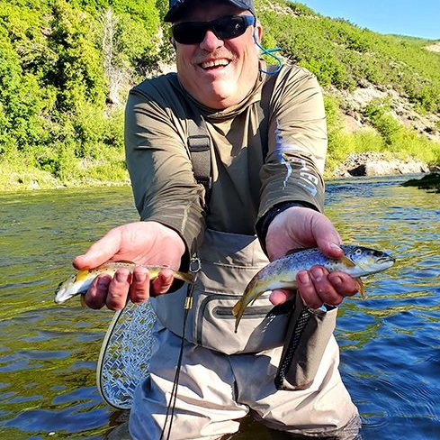 A Jeremy Allan Fly Fishing customer with a big brown trout on the Provo River