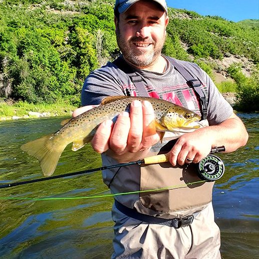 A Jeremy Allan Fly Fishing customer with a big brown trout on the Provo River