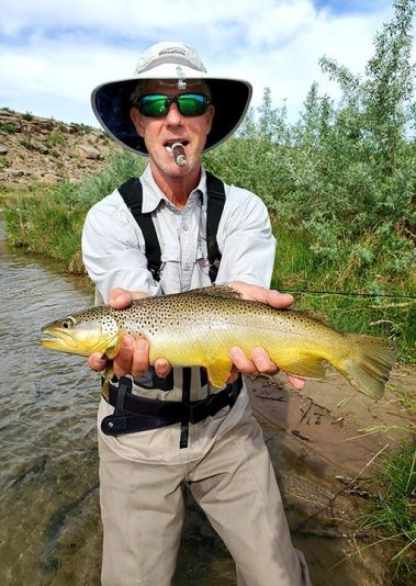 A Jeremy Allan Fly Fishing customer with a big brown trout