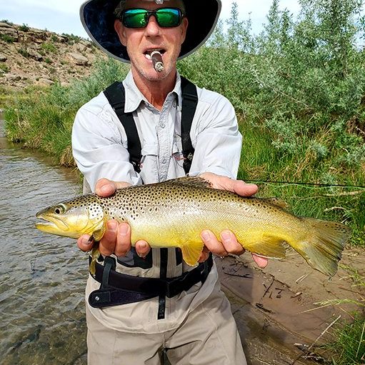 A Jeremy Allan Fly Fishing customer with a big brown trout