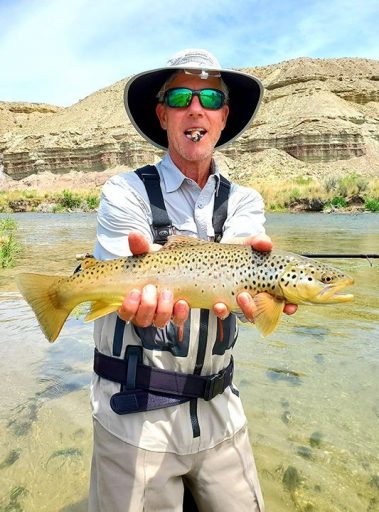 A Jeremy Allan Fly Fishing customer with a big brown trout
