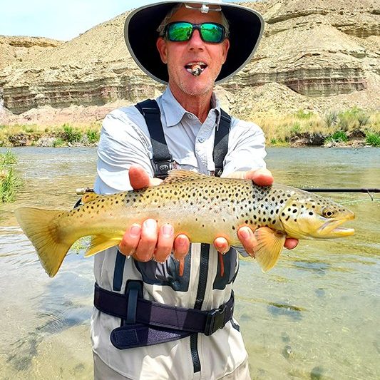 A Jeremy Allan Fly Fishing customer with a big brown trout