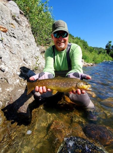 A Jeremy Allan Fly Fishing customer with a big brown trout on the Provo River