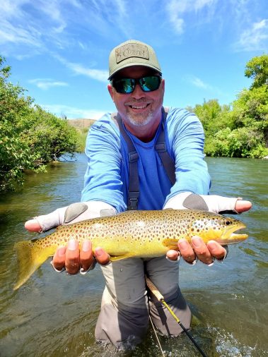 A Jeremy Allan Fly Fishing customer with a big brown trout on the Provo River
