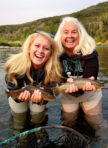 Mother and daughter fly fisherman with 2 brown trout caught on the Provo River