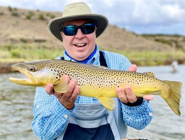 A Jeremy Allan Fly Fishing customer with a big brown trout