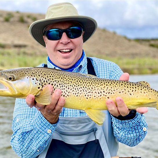 A Jeremy Allan Fly Fishing customer with a big brown trout