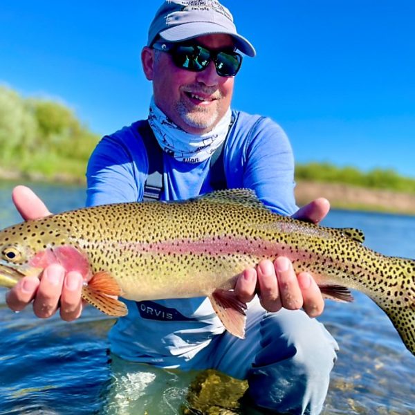 A Jeremy Allan Fly Fishing customer with a big rainbow trout caught on a small stream in Wyoming