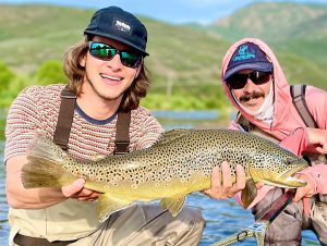 A Jeremy Allan Fly Fishing customer with a big brown trout caught on the middle Provo River