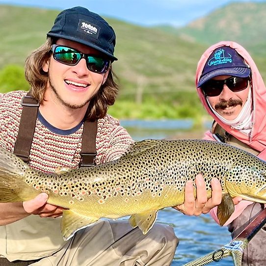 A Jeremy Allan Fly Fishing customer with a big brown trout caught on the middle Provo River