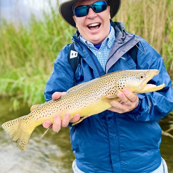 A Jeremy Allan Fly Fishing customer with a big brown trout
