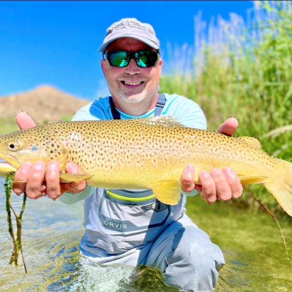 A Jeremy Allan Fly Fishing customer with a big brown trout