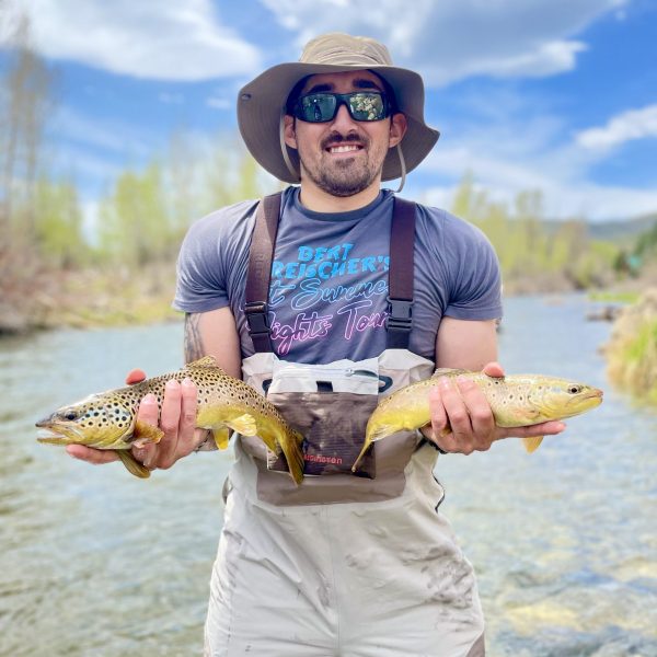 A Jeremy Allan Fly Fishing customer with two big brown trout on the Provo River