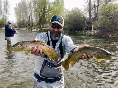 Jeremy Allan holding two nice brown trout caught on the Weber River