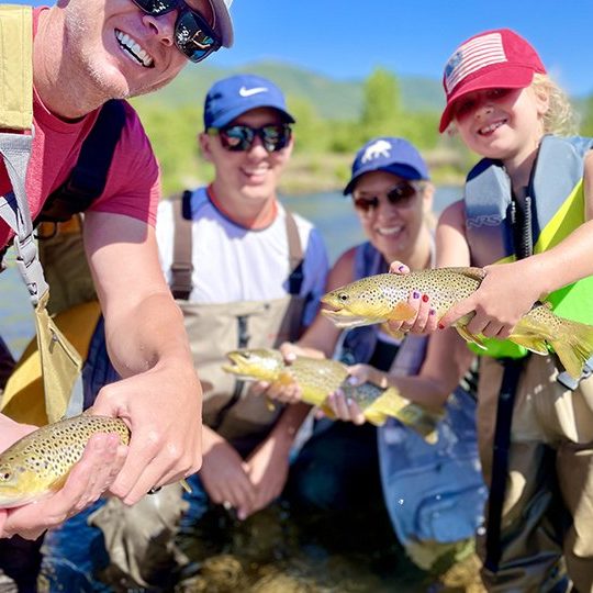 A family with three brown trout caught on the Provo River