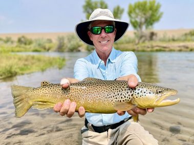 A Jeremy Allan Fly Fishing customer with a big brown trout caught on a small Utah stream