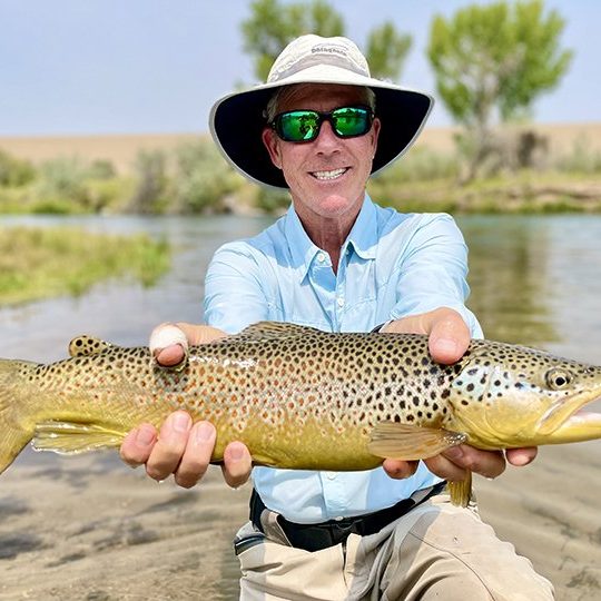 A Jeremy Allan Fly Fishing customer with a big brown trout caught on a small Utah stream