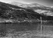 A lady fly fisherman casting on the Provo River in Utah