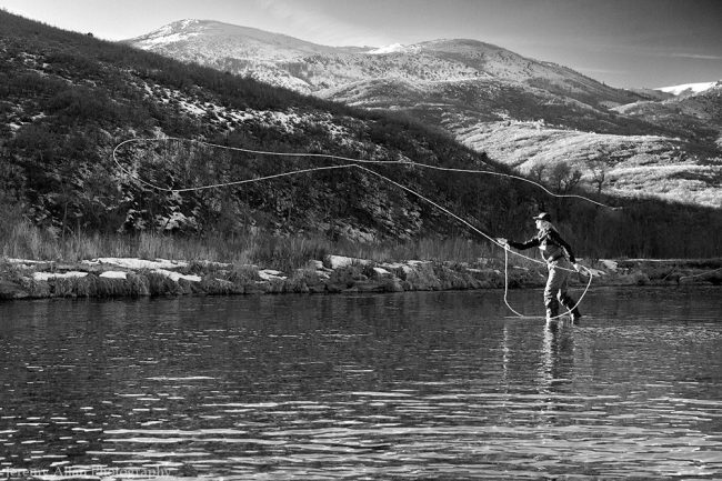 Winter Fly Fishing A lady fly fisherman casting on the Provo River in Utah