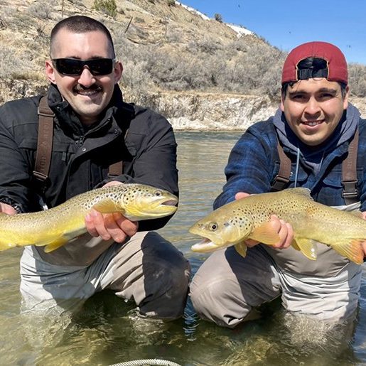 Two fly fisherman each with a nice brown trout caught on a small stream in Utah.