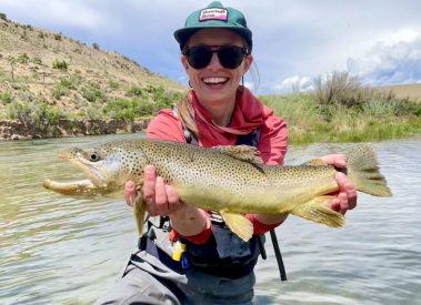 A happy lady with a big brown trout caught on fly fishing trip with Jeremy Allan