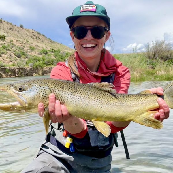 A happy lady with a big brown trout caught on fly fishing trip with Jeremy Allan