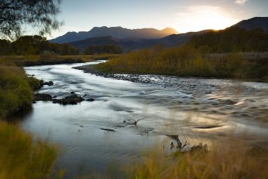 A long exposure photograph of the Provo River and Mt. Timpanogas with Fall colors by Jeremy Allan