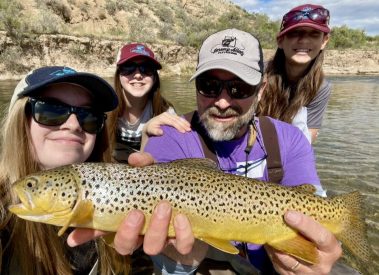 Salt Lake City fly fishing guide and photographer Jeremy Allan with family and holding a brown trout. Took the family out for a fun day of fishing on a Utah river. We had a lot of fun and caught some nice brown trout.