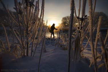A fly fisherman standing in the Provo River during the Winter