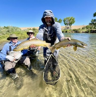 Owner and guide Jeremy Allan holding two big brown trout
