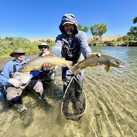 Owner and guide Jeremy Allan holding two big brown trout