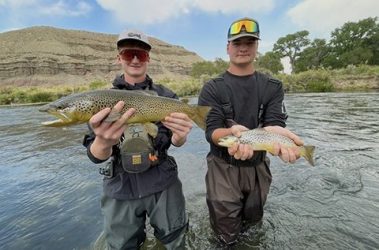 Two brothers holding brown trout caught in Utah