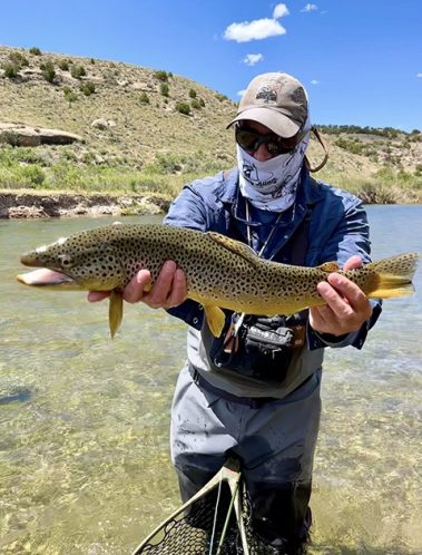Owner and guide Jeremy Allan with a nice brown trout caught on a Utah Stream.