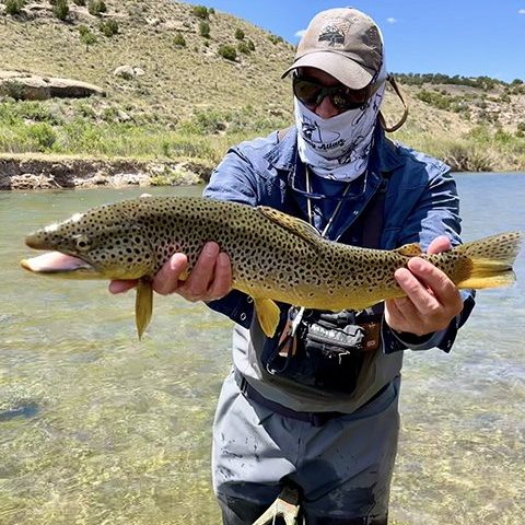 Owner and guide Jeremy Allan with a nice brown trout caught on a Utah Stream.